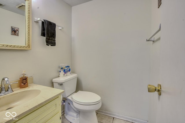 bathroom with visible vents, vanity, toilet, and tile patterned floors