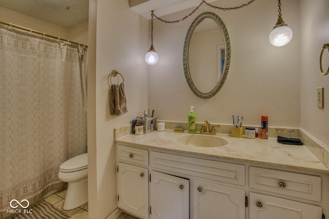 full bath featuring toilet, tile patterned floors, a textured ceiling, and vanity