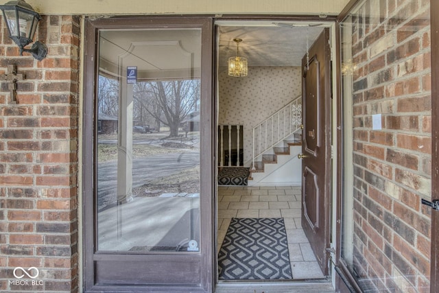 interior space with tile patterned flooring and brick wall