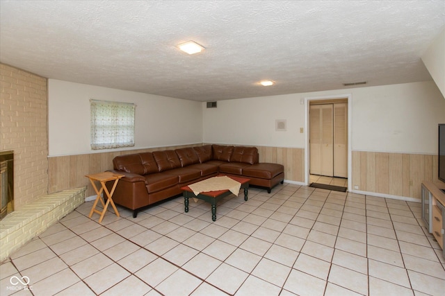 1612 Westbay Ct, Indianapolis, IN 46260 - living area with a wainscoted wall, wood walls, a textured ceiling, light tile patterned floors, and a brick fireplace