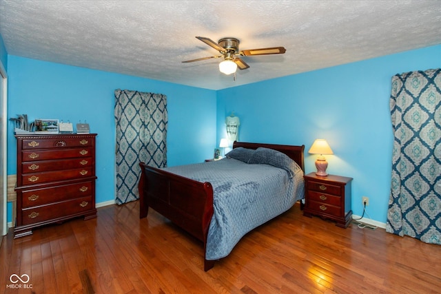 1612 Westbay Ct, Indianapolis, IN 46260 - bedroom featuring hardwood / wood-style flooring, a textured ceiling, baseboards, and a ceiling fan