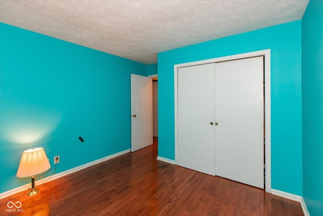 1612 Westbay Ct, Indianapolis, IN 46260 - unfurnished bedroom featuring wood finished floors, a textured ceiling, baseboards, and a closet