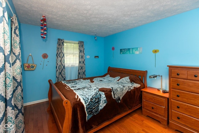 1612 Westbay Ct, Indianapolis, IN 46260 - bedroom with wood-type flooring, a textured ceiling, and baseboards