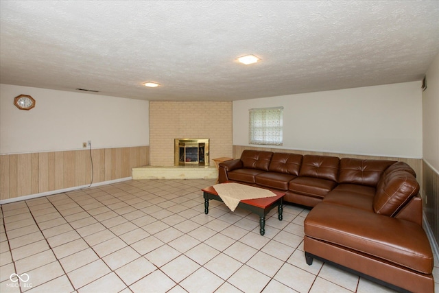 1612 Westbay Ct, Indianapolis, IN 46260 - living area with wainscoting, a fireplace, a textured ceiling, and light tile patterned floors