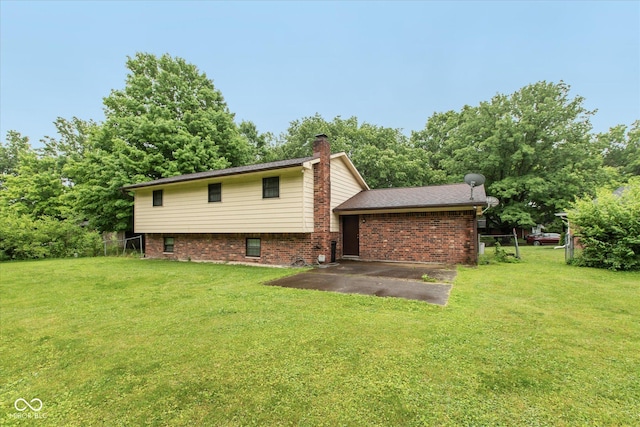 1612 Westbay Ct, Indianapolis, IN 46260 - back of property featuring a patio area, brick siding, and a chimney