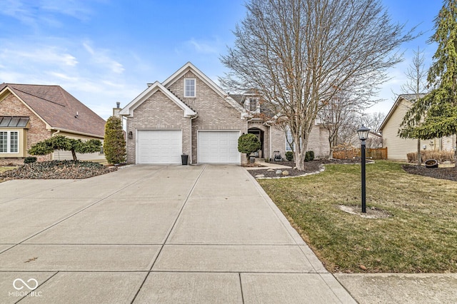 traditional home featuring concrete driveway, brick siding, a front lawn, and fence