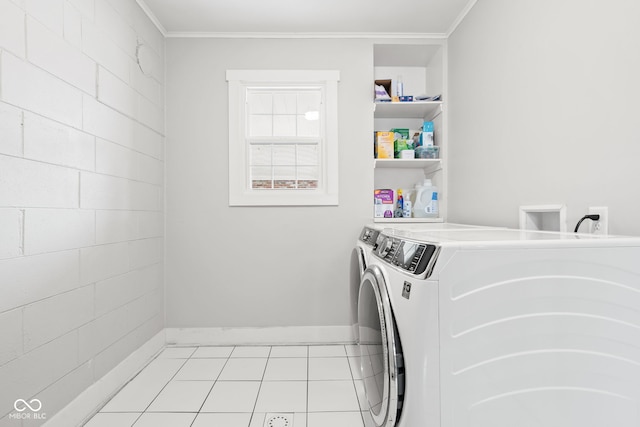 washroom with light tile patterned floors, independent washer and dryer, laundry area, and crown molding