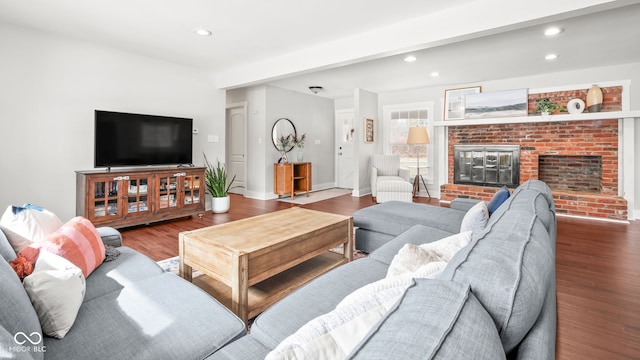 living room featuring recessed lighting, wood finished floors, and a fireplace