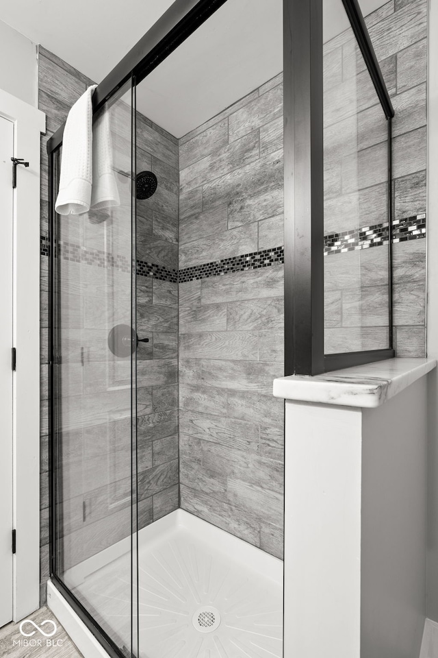 full bath featuring a shower stall