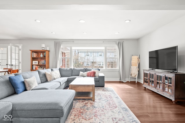 living room featuring recessed lighting, wood finished floors, and baseboards