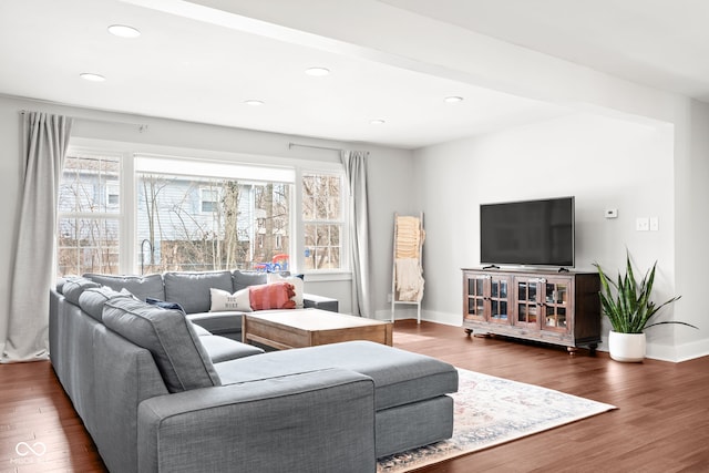 living area with recessed lighting, wood finished floors, and baseboards