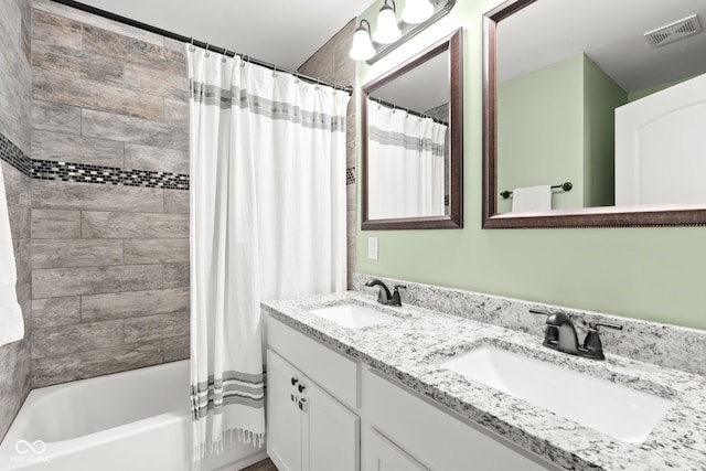 bathroom featuring double vanity, shower / bathtub combination with curtain, visible vents, and a sink