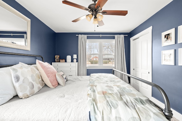 bedroom with a ceiling fan and a closet