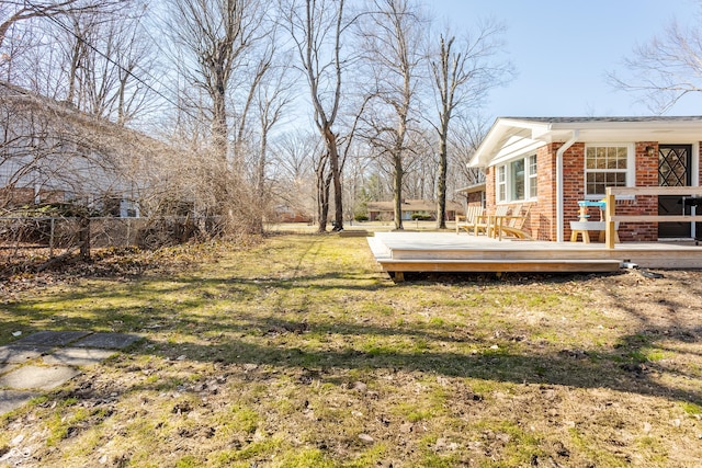 view of yard with a wooden deck and fence