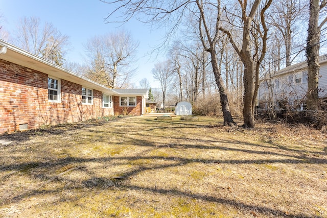 view of yard featuring an outbuilding and a storage unit