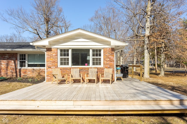 wooden deck featuring a grill