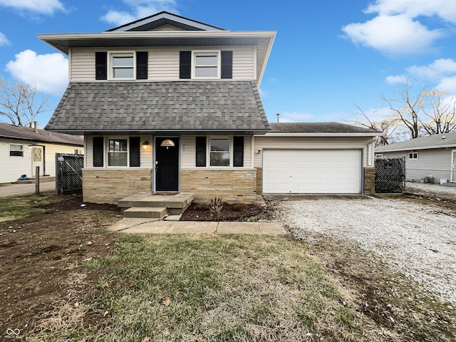 view of front of property featuring stone siding, a shingled roof, and driveway