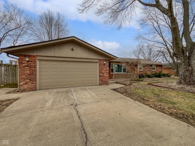 ranch-style home with driveway, a garage, covered porch, fence, and brick siding