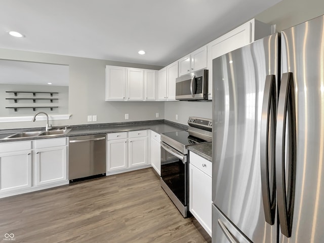 kitchen featuring white cabinets, stainless steel appliances, and a sink