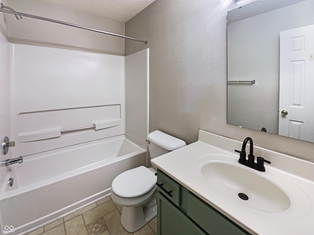 bathroom with a textured wall, toilet, tub / shower combination, vanity, and a textured ceiling