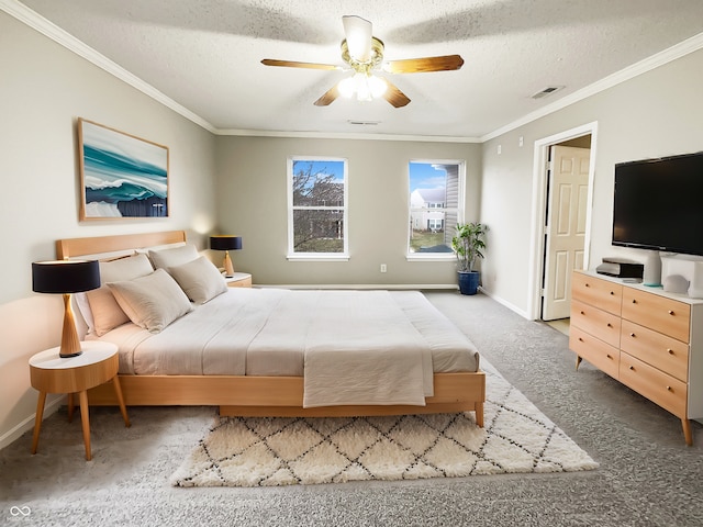 carpeted bedroom featuring visible vents, crown molding, a textured ceiling, and baseboards