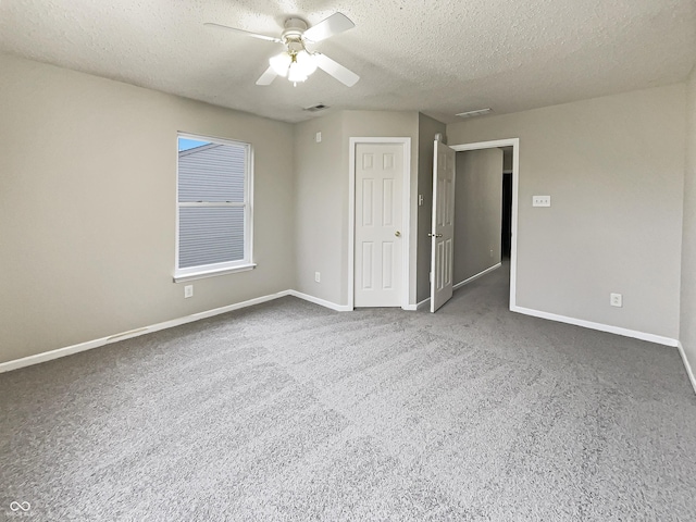 unfurnished bedroom with visible vents, baseboards, ceiling fan, and a textured ceiling