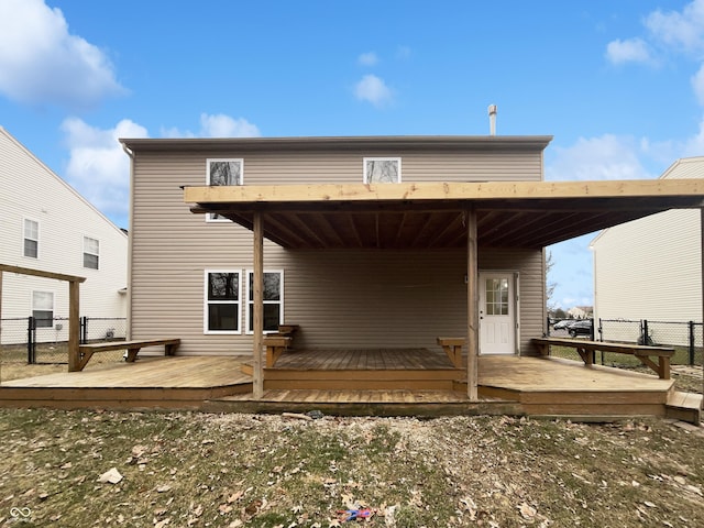 back of property featuring fence and a deck