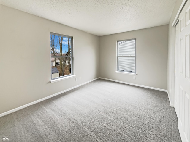 unfurnished bedroom with carpet, multiple windows, baseboards, and a closet