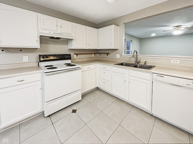 kitchen featuring white appliances, light countertops, under cabinet range hood, white cabinetry, and a sink