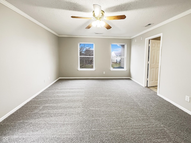 carpeted empty room featuring a textured ceiling, baseboards, visible vents, and crown molding