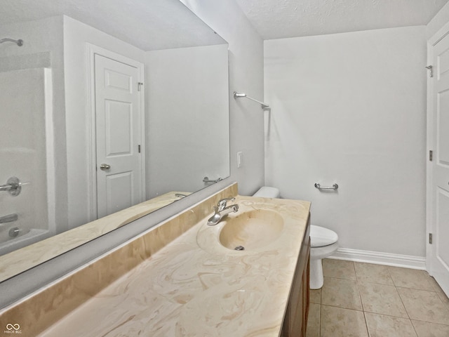 full bathroom featuring a textured ceiling, toilet, vanity, baseboards, and tile patterned floors