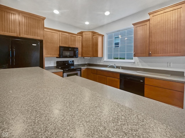 kitchen featuring black appliances, a sink, and recessed lighting