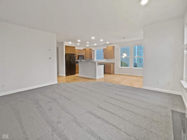 unfurnished living room with light wood-style floors, recessed lighting, and baseboards