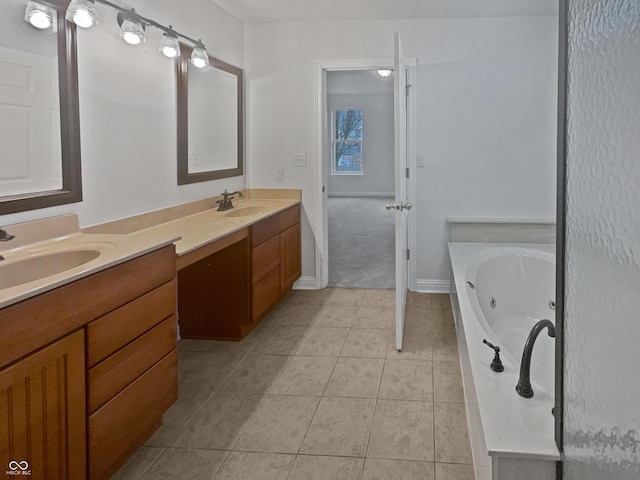 bathroom featuring double vanity, tile patterned flooring, a jetted tub, and a sink