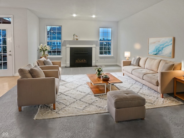 living area featuring baseboards and a tiled fireplace