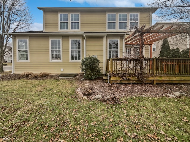 back of house featuring a lawn, a deck, and a pergola