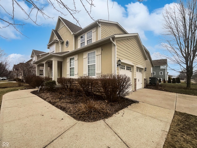 view of side of home featuring central AC, concrete driveway, and stucco siding