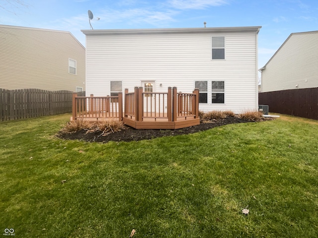 rear view of house with a deck, a lawn, fence, and central air condition unit