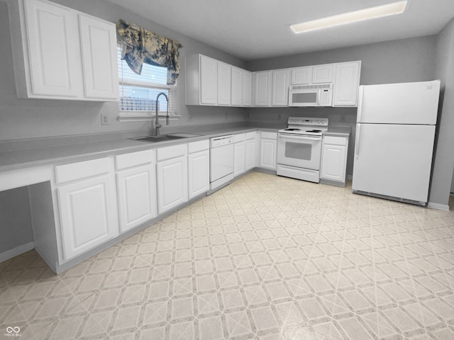 kitchen with white appliances, baseboards, light floors, white cabinetry, and a sink