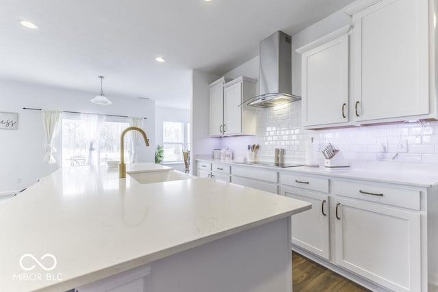 4078 Omaha Dr, Bargersville, IN 46106 - kitchen with black electric stovetop, a sink, light countertops, wall chimney range hood, and backsplash