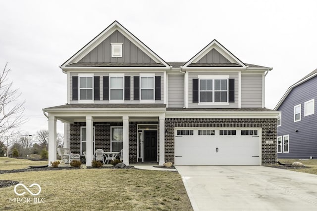 view of front of home with concrete driveway, a porch, board and batten siding, and brick siding