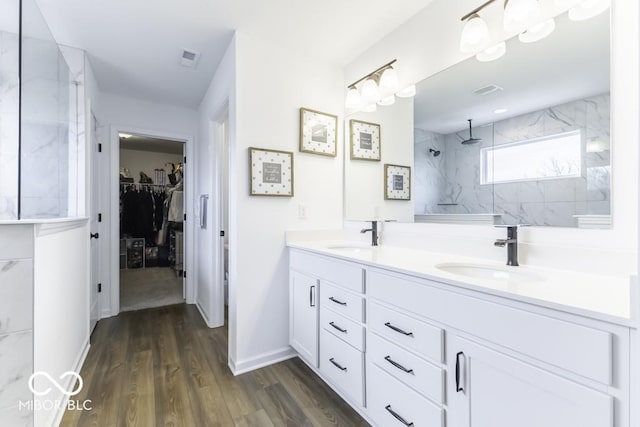 4078 Omaha Dr, Bargersville, IN 46106 - bathroom featuring double vanity, a marble finish shower, a sink, and wood finished floors