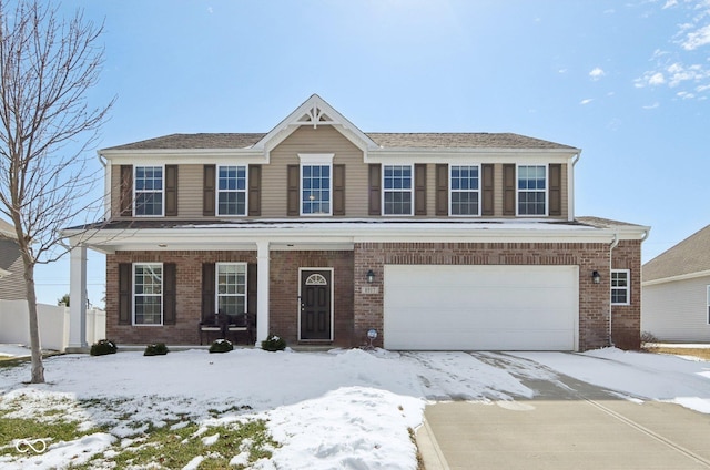 view of front facade featuring an attached garage, covered porch, driveway, and brick siding