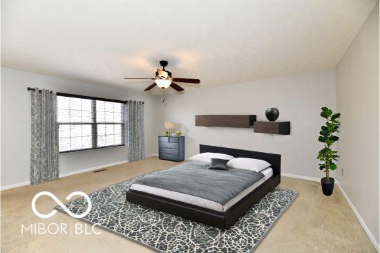 bedroom with a ceiling fan, carpet floors, and baseboards