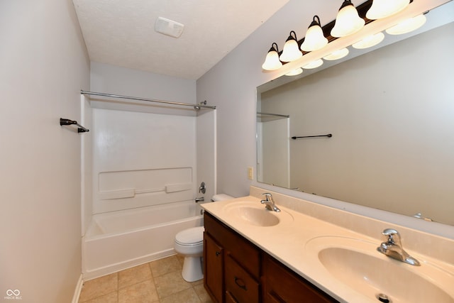 full bath featuring a sink, a textured ceiling, toilet, and double vanity