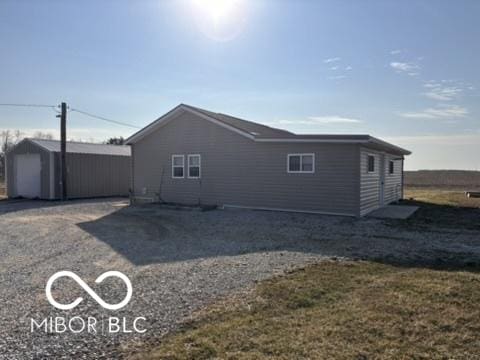 back of property with an outbuilding