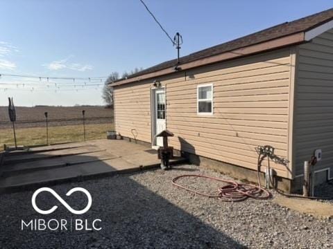 rear view of property featuring a patio and fence