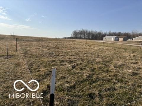 view of yard with a rural view