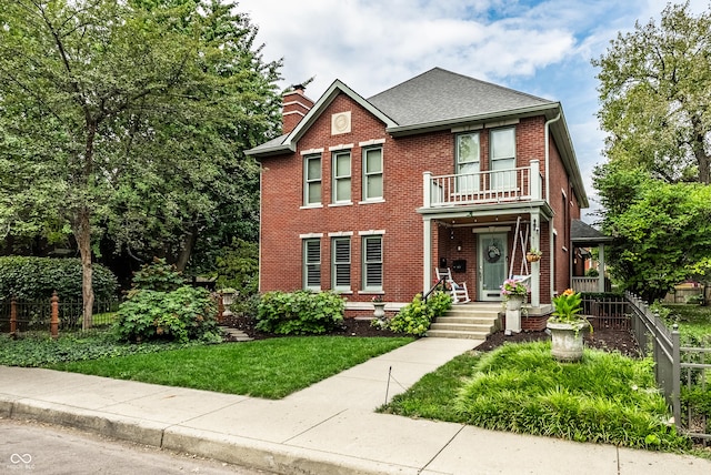 view of front of home featuring brick siding, a shingled roof, fence, a front lawn, and a chimney