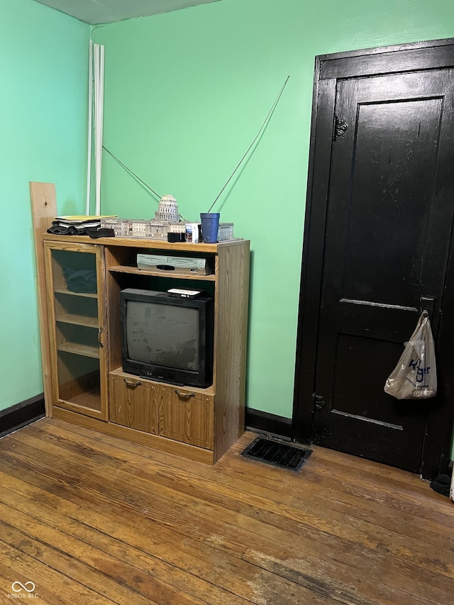 interior details featuring visible vents, baseboards, and wood finished floors